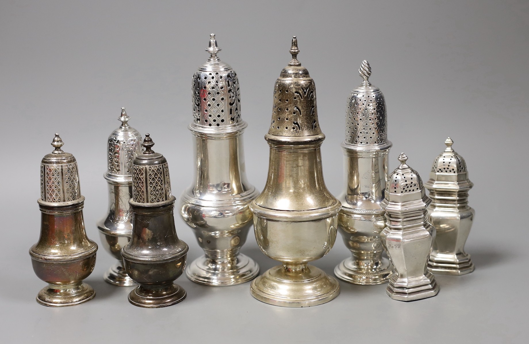 A George V silver baluster caster, Samuel Wood, London, 1759, 17.5cm, two other Georgian silver pepperettes and five late silver casters/pepperettes, gross weight 25oz.
